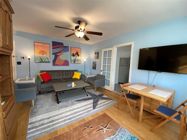 living room with ceiling fan and light hardwood / wood-style floors