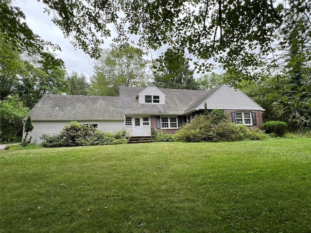 cape cod home featuring a front yard