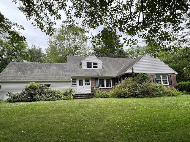 cape cod house featuring a front lawn