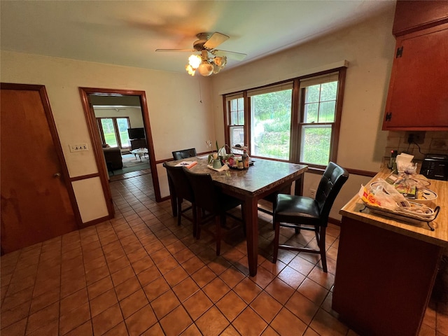 tiled dining area featuring ceiling fan