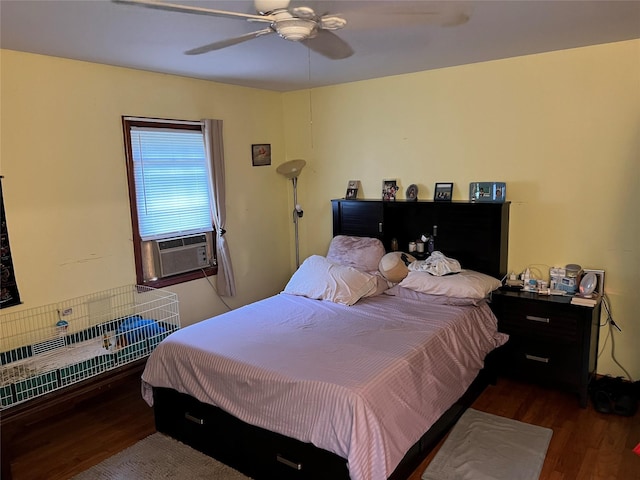 bedroom with dark hardwood / wood-style floors, ceiling fan, and cooling unit