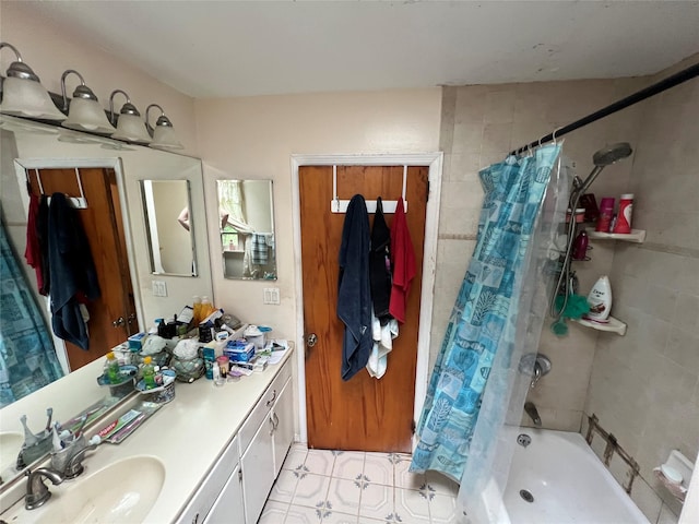 bathroom with shower / tub combo, vanity, and tile patterned floors