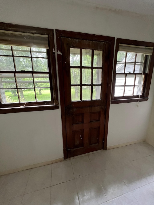 entryway featuring a wealth of natural light and light tile patterned flooring