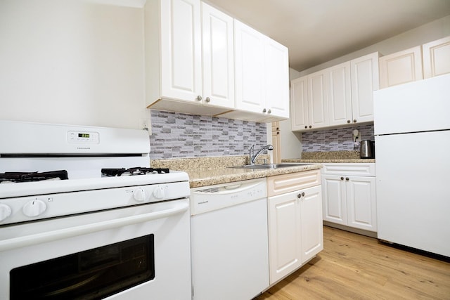 kitchen with white appliances, white cabinetry, sink, light hardwood / wood-style flooring, and tasteful backsplash