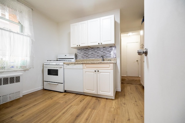 kitchen featuring white cabinetry, white appliances, light hardwood / wood-style flooring, radiator, and decorative backsplash