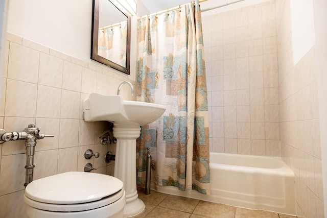 bathroom featuring tile walls, tile patterned flooring, shower / bath combo with shower curtain, and toilet