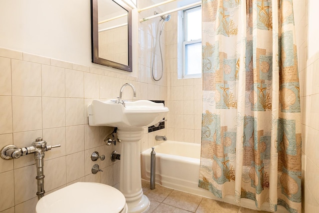 bathroom featuring toilet, tile patterned floors, tile walls, and shower / tub combo with curtain