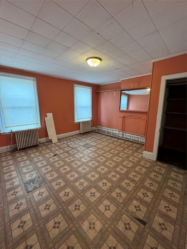 empty room with radiator heating unit and baseboard heating