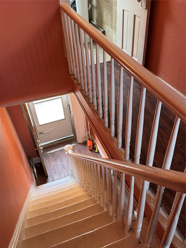 stairway featuring wood-type flooring