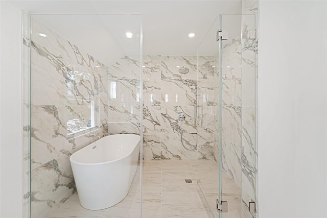 bathroom featuring tile walls and independent shower and bath