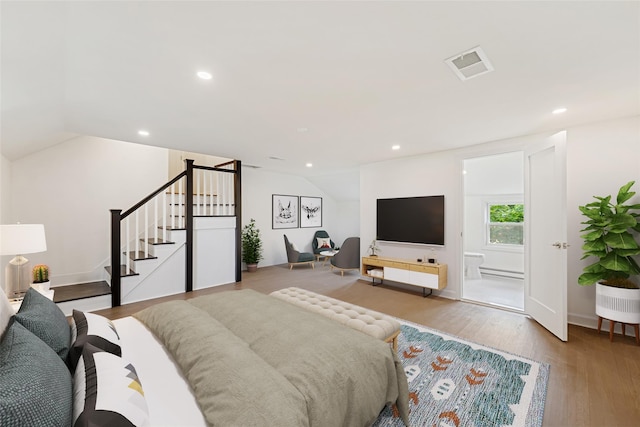 bedroom featuring light hardwood / wood-style flooring and lofted ceiling