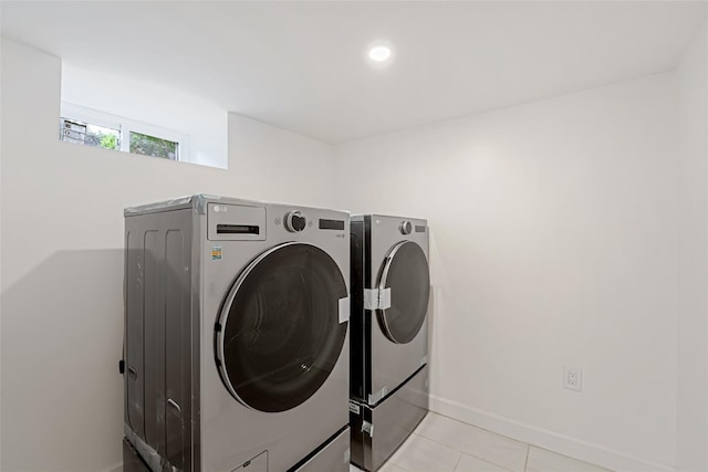 laundry room with light tile patterned flooring and independent washer and dryer