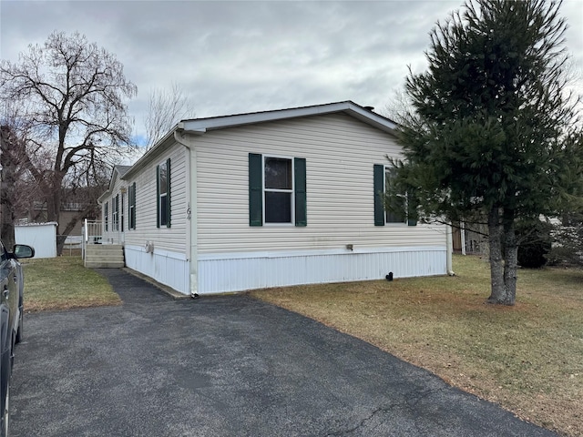 view of property exterior featuring a lawn