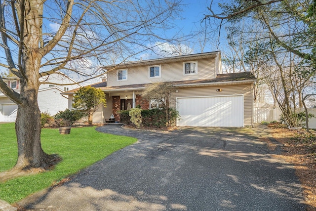 front of property featuring a front yard and a garage