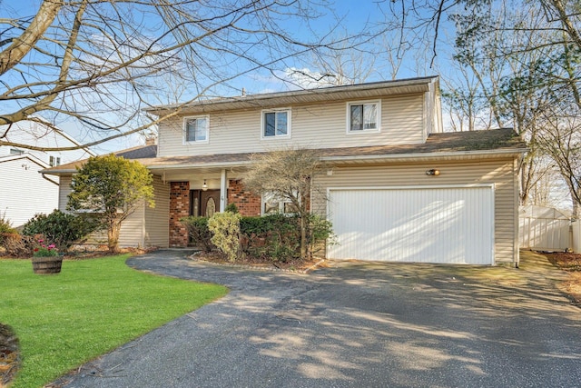 view of front of home featuring a front yard and a garage