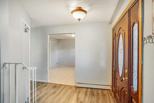 entrance foyer featuring baseboard heating and light hardwood / wood-style flooring