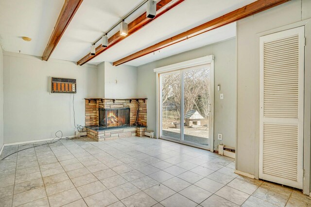 unfurnished living room with a fireplace, a wall mounted AC, beamed ceiling, light tile patterned flooring, and a baseboard radiator