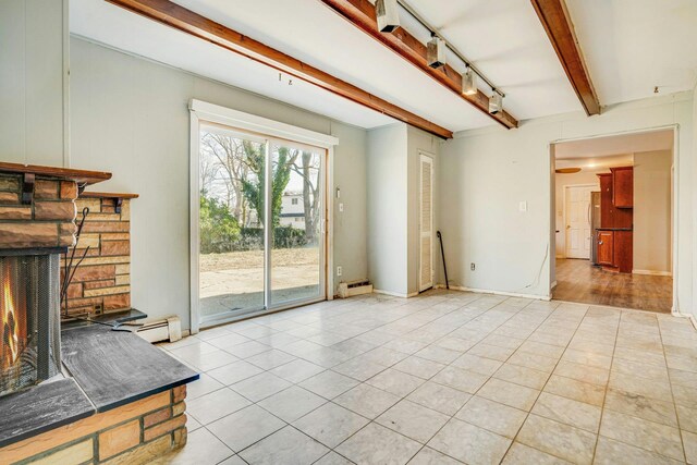 unfurnished living room with a fireplace, beamed ceiling, a baseboard radiator, and light tile patterned floors