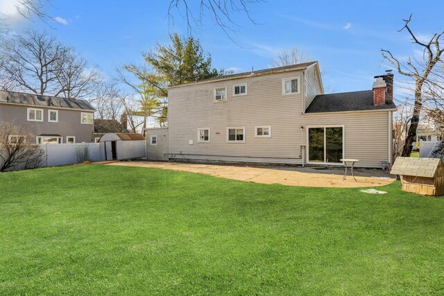 rear view of property with a patio area and a lawn