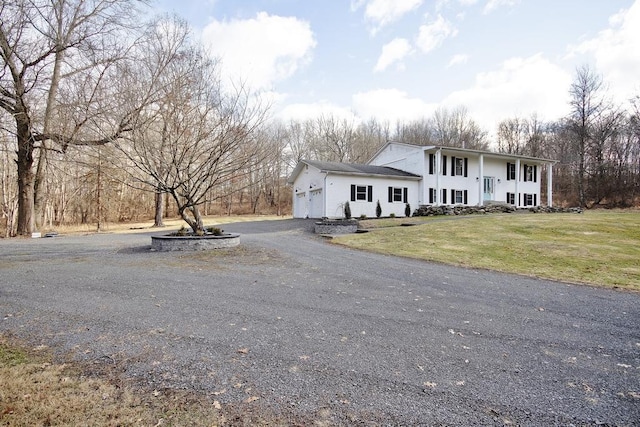 exterior space featuring a garage and a front lawn