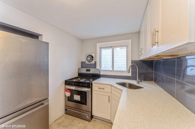 kitchen with light stone countertops, backsplash, stainless steel appliances, and sink