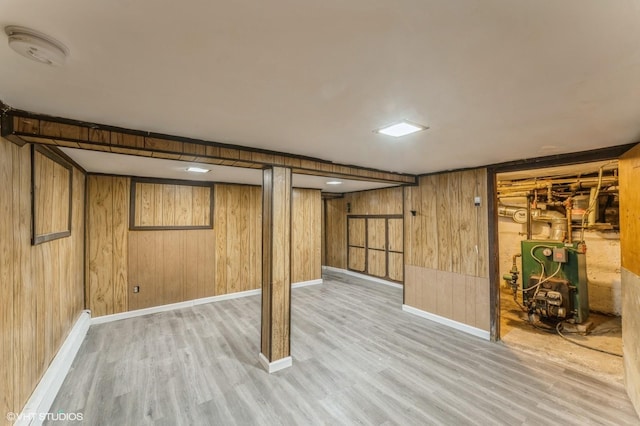 basement with wooden walls and light hardwood / wood-style floors