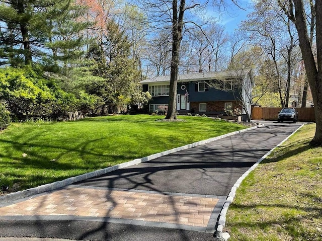 split foyer home with a front lawn