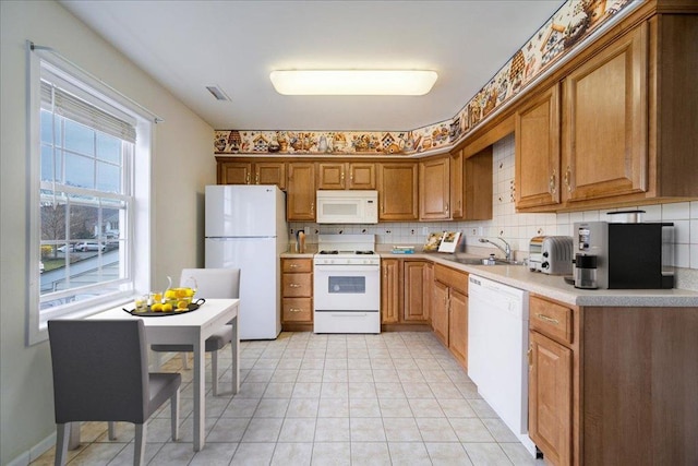 kitchen with light tile patterned flooring, white appliances, tasteful backsplash, and sink