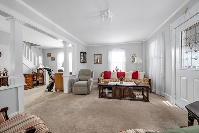 carpeted living room featuring crown molding and decorative columns