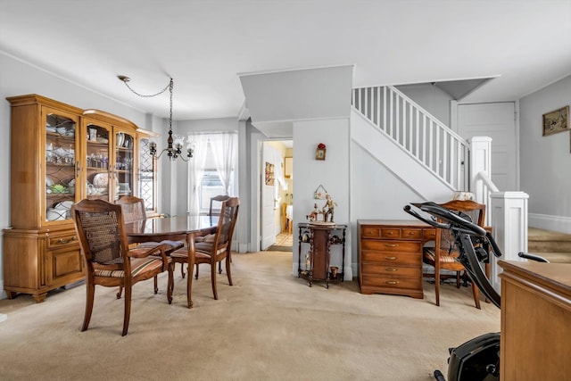 dining space with light carpet and a notable chandelier