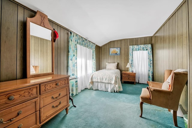 bedroom featuring carpet, wooden walls, and vaulted ceiling