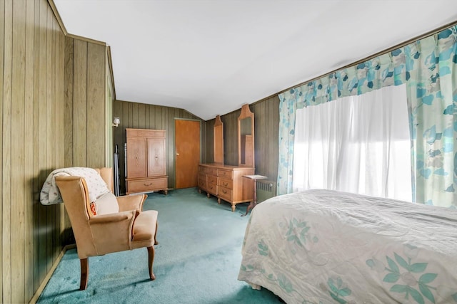 carpeted bedroom featuring wood walls and vaulted ceiling