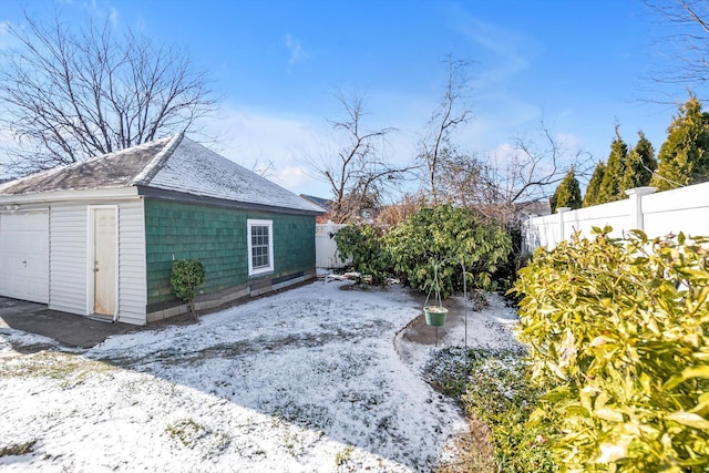 yard layered in snow featuring an outbuilding