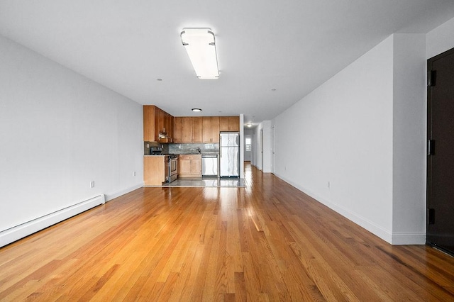 unfurnished living room with a baseboard radiator and light hardwood / wood-style floors