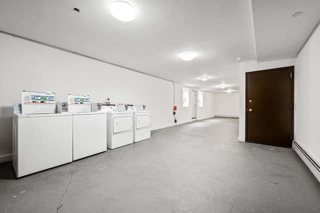 clothes washing area featuring separate washer and dryer and a baseboard heating unit