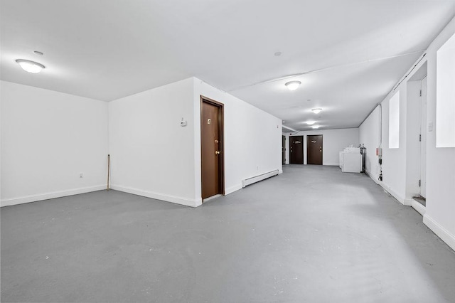 interior space featuring washer / clothes dryer and a baseboard heating unit