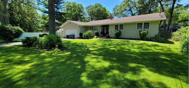 view of front facade featuring a garage and a front lawn