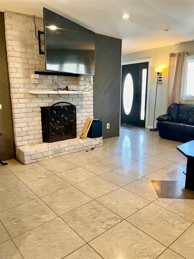 unfurnished living room with a fireplace and light tile patterned floors