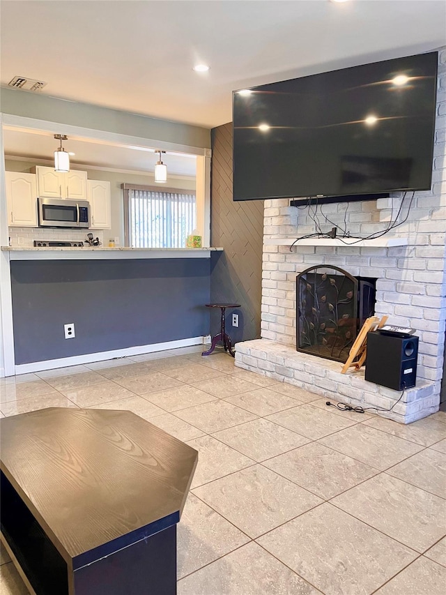 unfurnished living room featuring a fireplace and light tile patterned floors