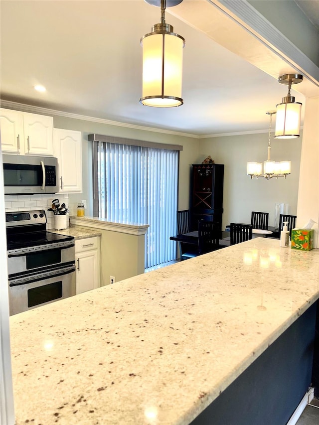 kitchen featuring light stone countertops, white cabinetry, hanging light fixtures, stainless steel appliances, and decorative backsplash