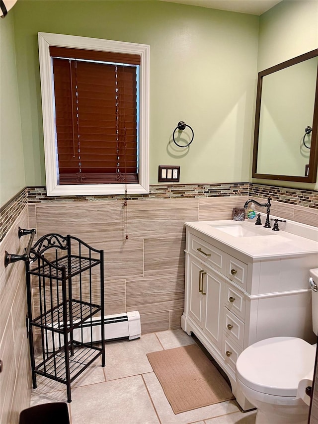 bathroom featuring tile patterned flooring, vanity, toilet, and tile walls