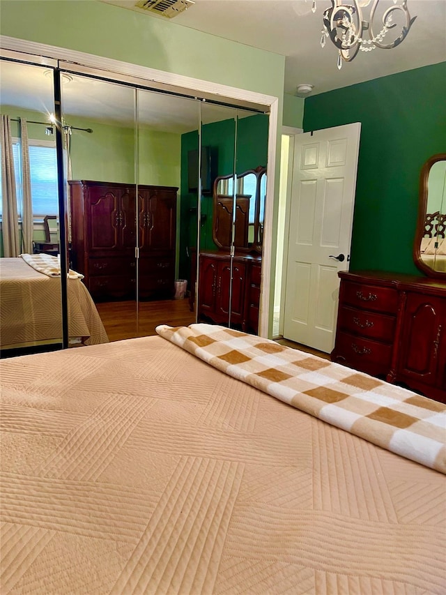 bedroom with a chandelier and a closet