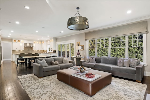 living room with ornamental molding and hardwood / wood-style floors