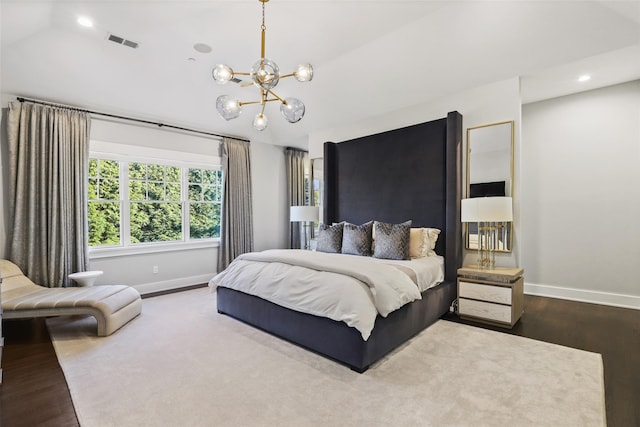 bedroom featuring hardwood / wood-style floors and a notable chandelier