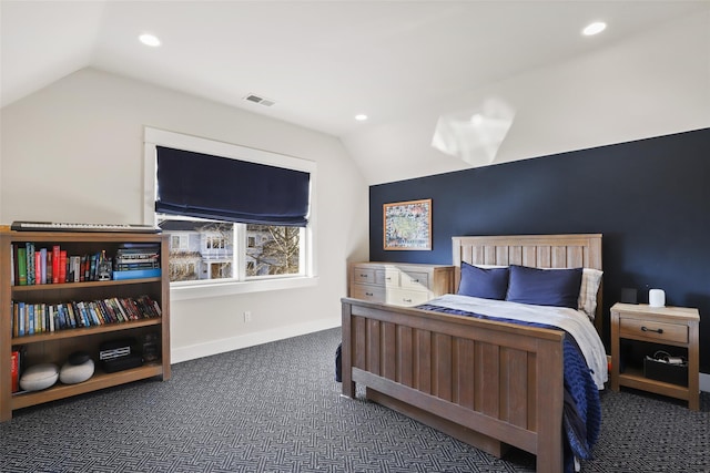 bedroom with dark colored carpet and vaulted ceiling