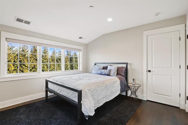 bedroom with dark wood-type flooring and vaulted ceiling