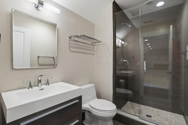 bathroom with an enclosed shower, vanity, and toilet