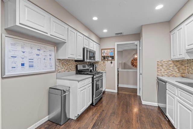 23 Old Brick Rd, New City, NY 10956 - kitchen with appliances with stainless steel finishes, light countertops, white cabinets, dark wood finished floors, and recessed lighting