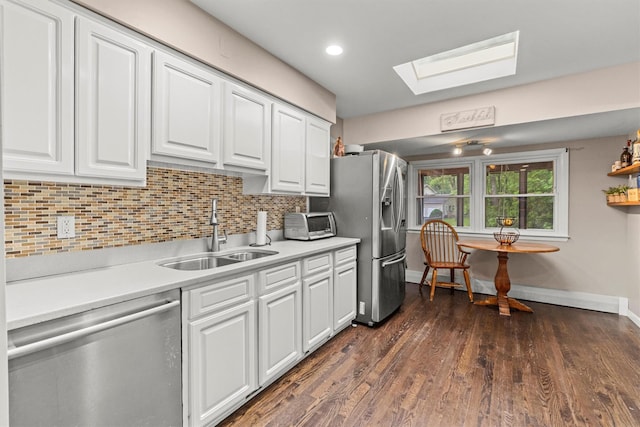 23 Old Brick Rd, New City, NY 10956 - kitchen featuring stainless steel appliances, a skylight, white cabinetry, and recessed lighting