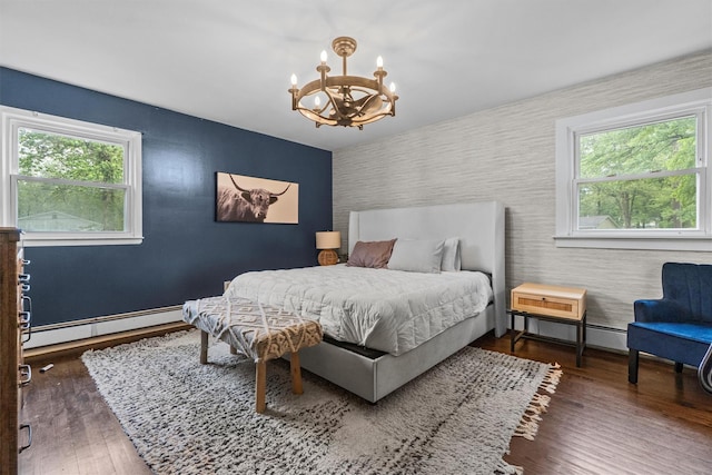 23 Old Brick Rd, New City, NY 10956 - bedroom with wallpapered walls, an accent wall, a chandelier, a baseboard heating unit, and multiple windows